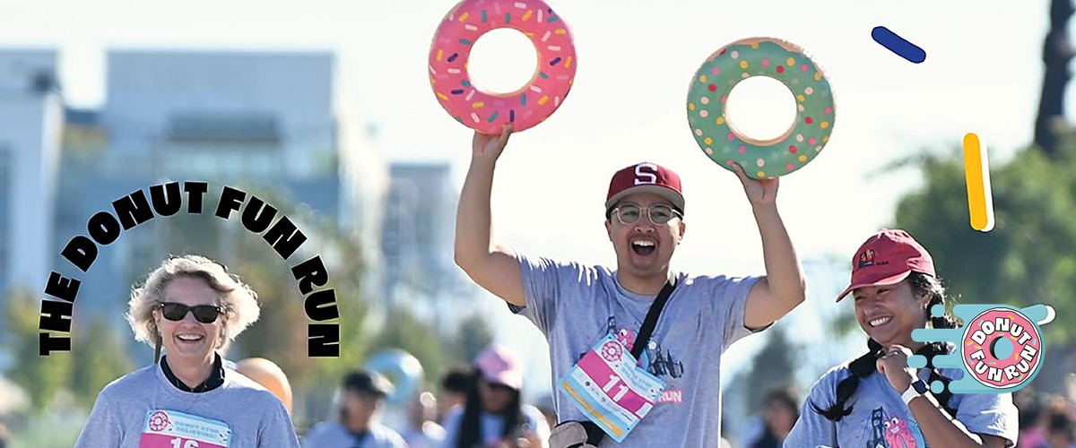 Runners holding donut inflatables at The Donut Fun Run